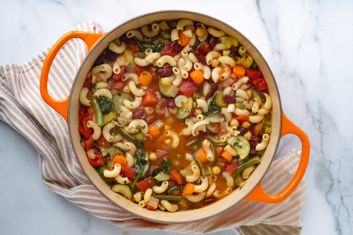 A large dutch oven filled with homemade minestrone soup.