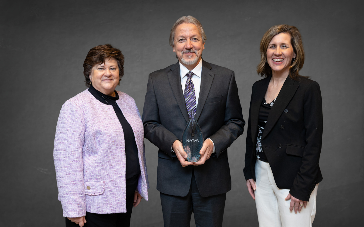 Susan Pekarek (left), a member of the NACWA Board and Awards Committee, presents an award to ALCOSAN’s Doug Jackson, operations and maintenance, and Michelle Buys, environmental compliance, during NACWA’s Winter Awards Ceremony on Feb. 3 in Miami.
